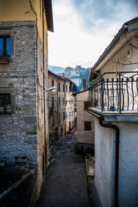 Narrow alley amidst old buildings in town