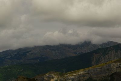 Scenic view of mountains against cloudy sky