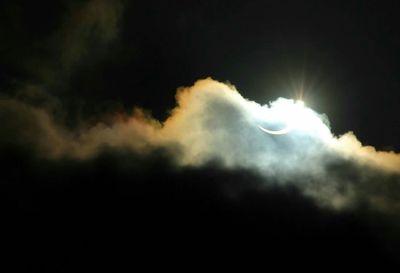 Low angle view of cloudy sky at night