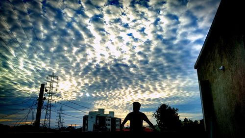 Silhouette of people against dramatic sky