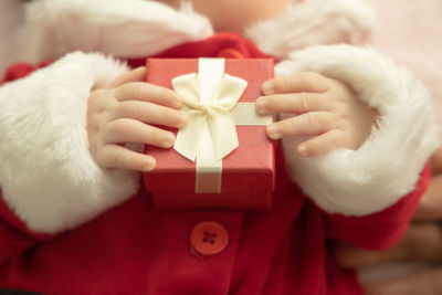 Close-up of hand holding christmas decoration in box