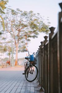 Bicycle parked by railing in city