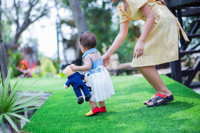 Mother and daughter on grass