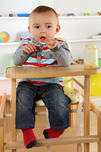 Portrait of cute girl sitting on table