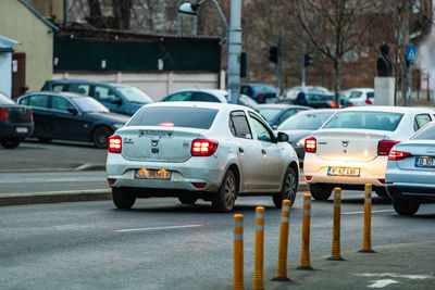 Vehicles on road along buildings