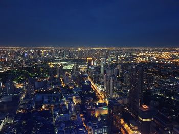 High angle view of illuminated city buildings at night