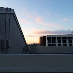 Buildings against sky at sunset