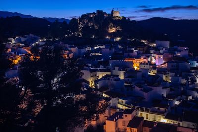 High angle view of illuminated buildings in city at night