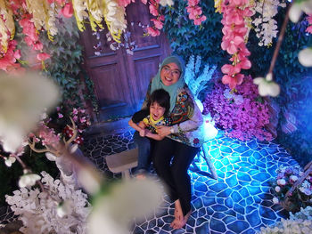 High angle view of mother and son sitting on bench