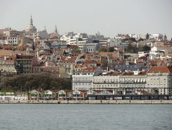 Buildings in city against clear sky