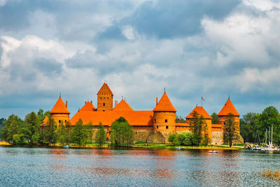 Trakai island castle amidst lake galve against cloudy sky