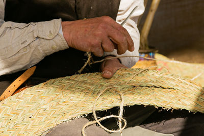 Craftsman's hands, working the esparto grass, handicrafts in the street