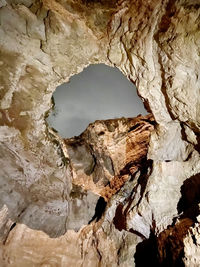 Rock formation seen through hole in cave