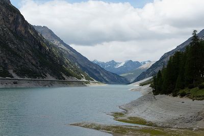 Scenic view of river amidst mountains against sky