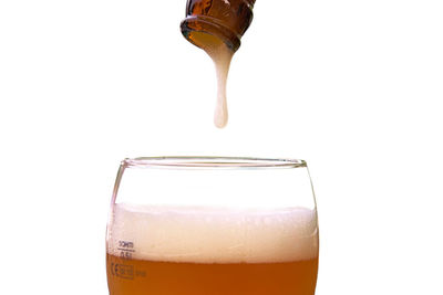 Close-up of beer glass against white background