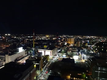 High angle view of illuminated buildings against clear sky at night