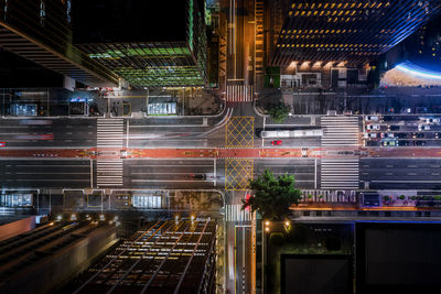 Light trails on city street by buildings at night