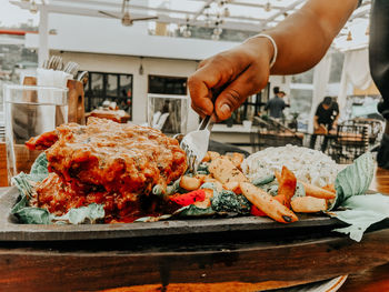 Cropped image of person preparing food on table