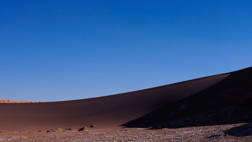 View of desert against blue sky