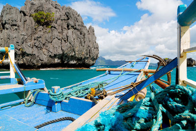 Boats moored on sea against blue sky