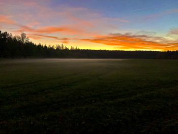 Scenic view of field against sky during sunset