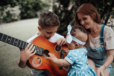 Women playing guitar at music concert