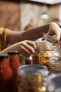 Cropped hands of woman preparing food on table