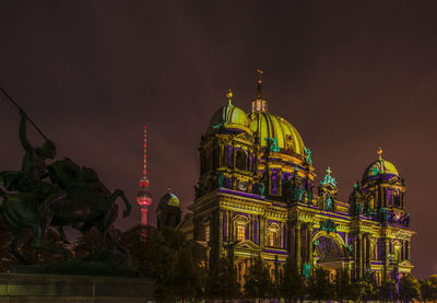 Low angle view of illuminated cathedral against sky at night