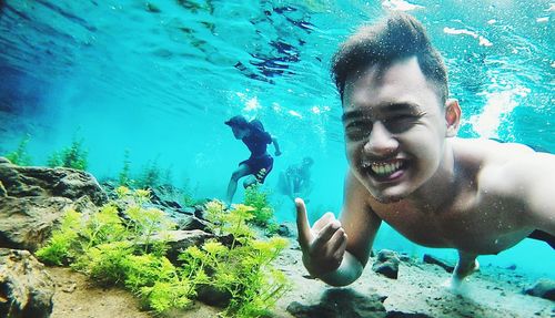 Portrait of young man swimming in sea