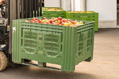 Various fruits in basket on crate