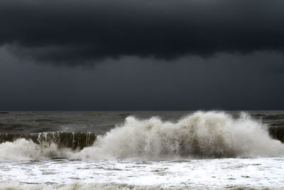 Scenic view of sea against storm clouds