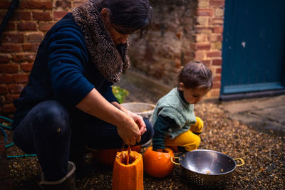 Mother and child are preparing pumpkins for halloween 