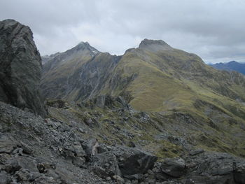 Scenic view of mountains against cloudy sky