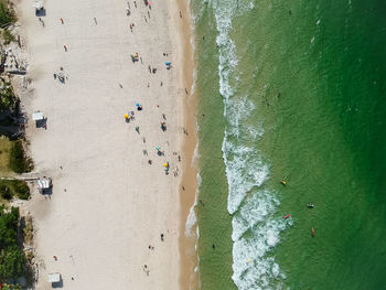 People on beach against sky