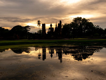 Reflection of building in lake at sunset