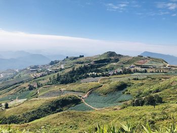 Scenic view of landscape and mountains against sky