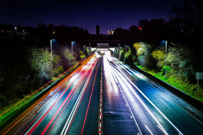 High angle view of light trails on highway at night