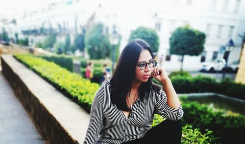 Beautiful young woman standing in city