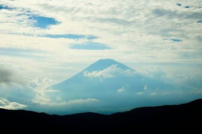 Scenic view of mountains against cloudy sky