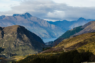 Scenic view of mountains against cloudy sky