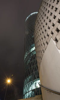 Low angle view of illuminated building against sky at night