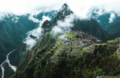 Scenic view of mountains against cloudy sky