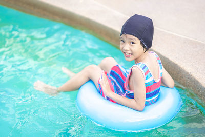 Portrait of happy boy in swimming pool