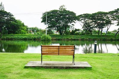 Gazebo in park by lake against sky
