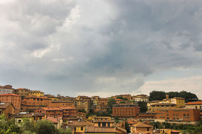 Cityscape against cloudy sky