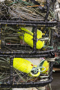 Close-up of yellow fishing net in cage