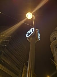 Low angle view of illuminated street light at night