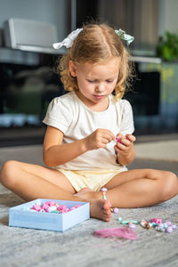 Side view of girl drawing on table