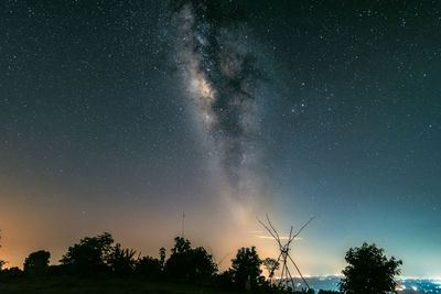 Low angle view of silhouette trees against sky at night