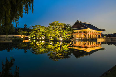 Gazebo by lake against clear sky